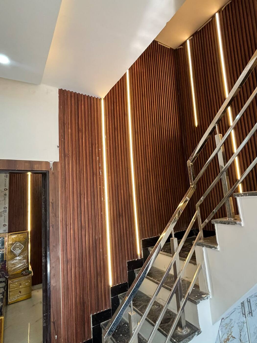 Steel railing and warm strip lights on staircase